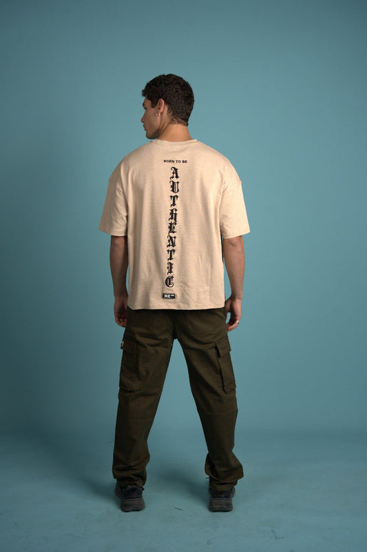 Person wearing a beige t-shirt with text on a blue background